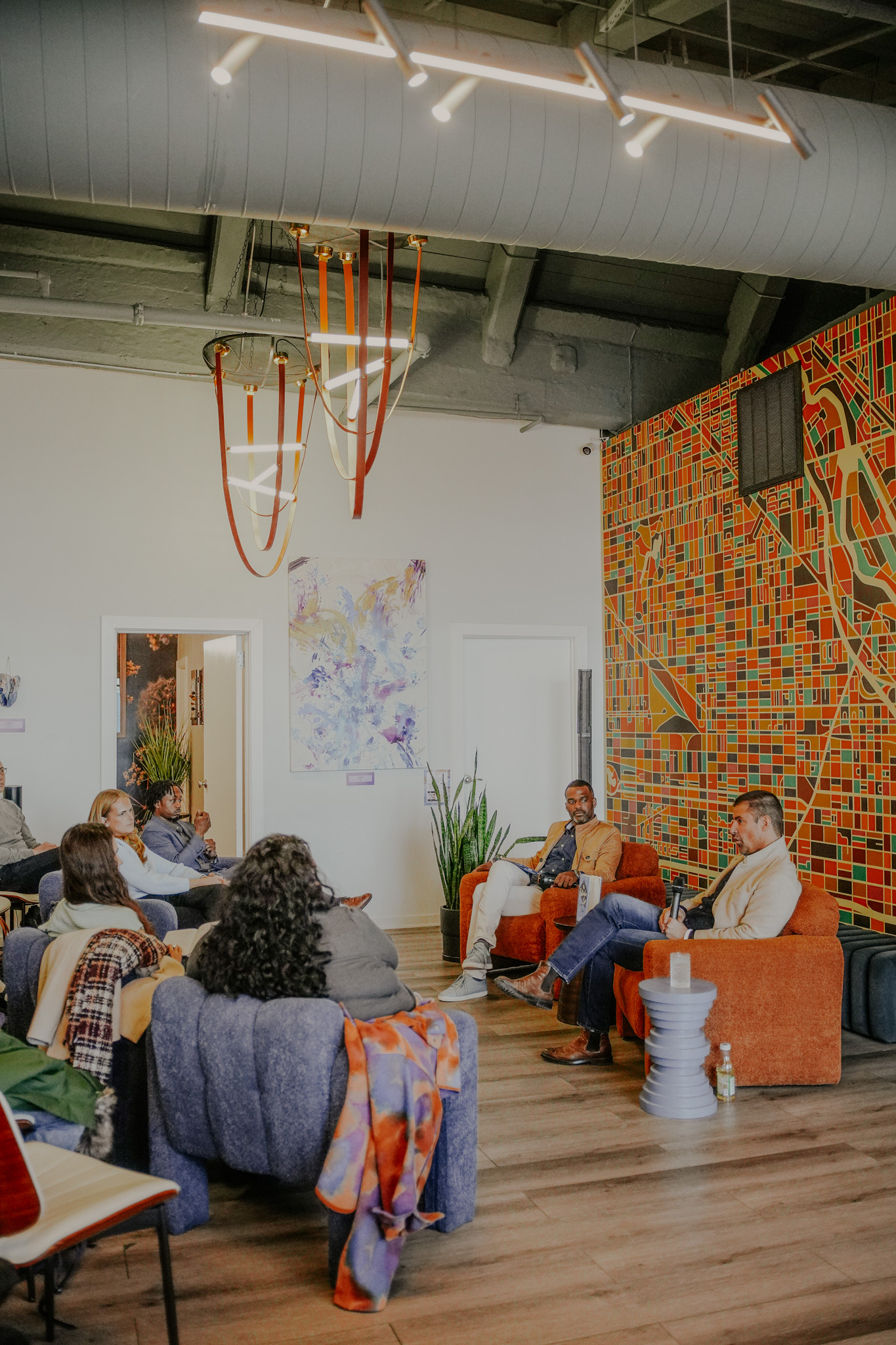 A panel conversation with the Chicago mural behind