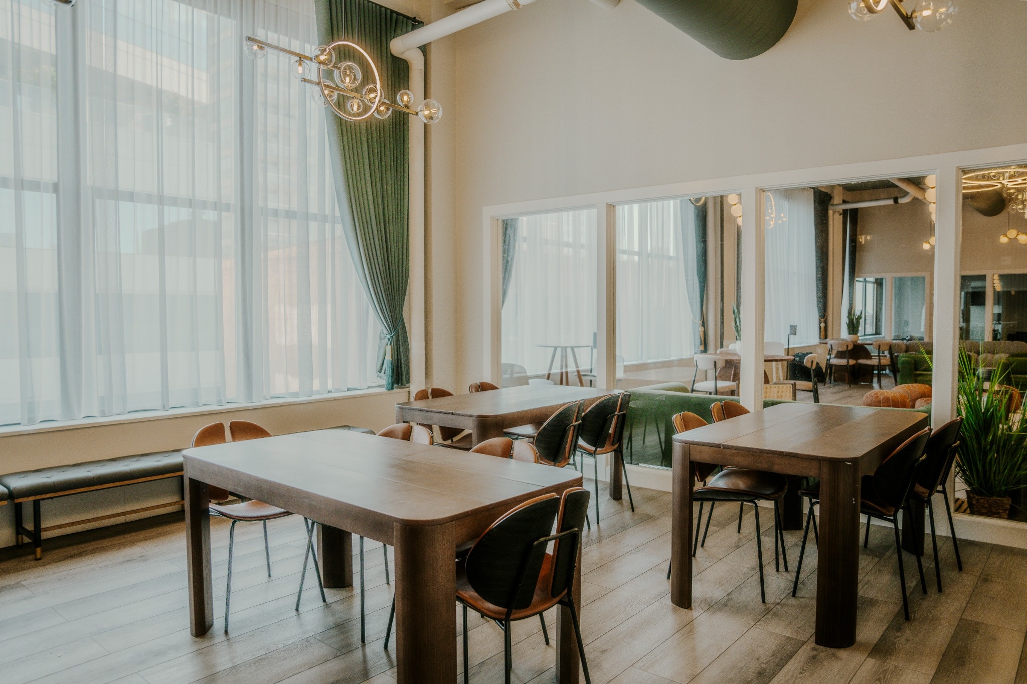 Dining tables by the windows at the River North clubhouse in Chicago