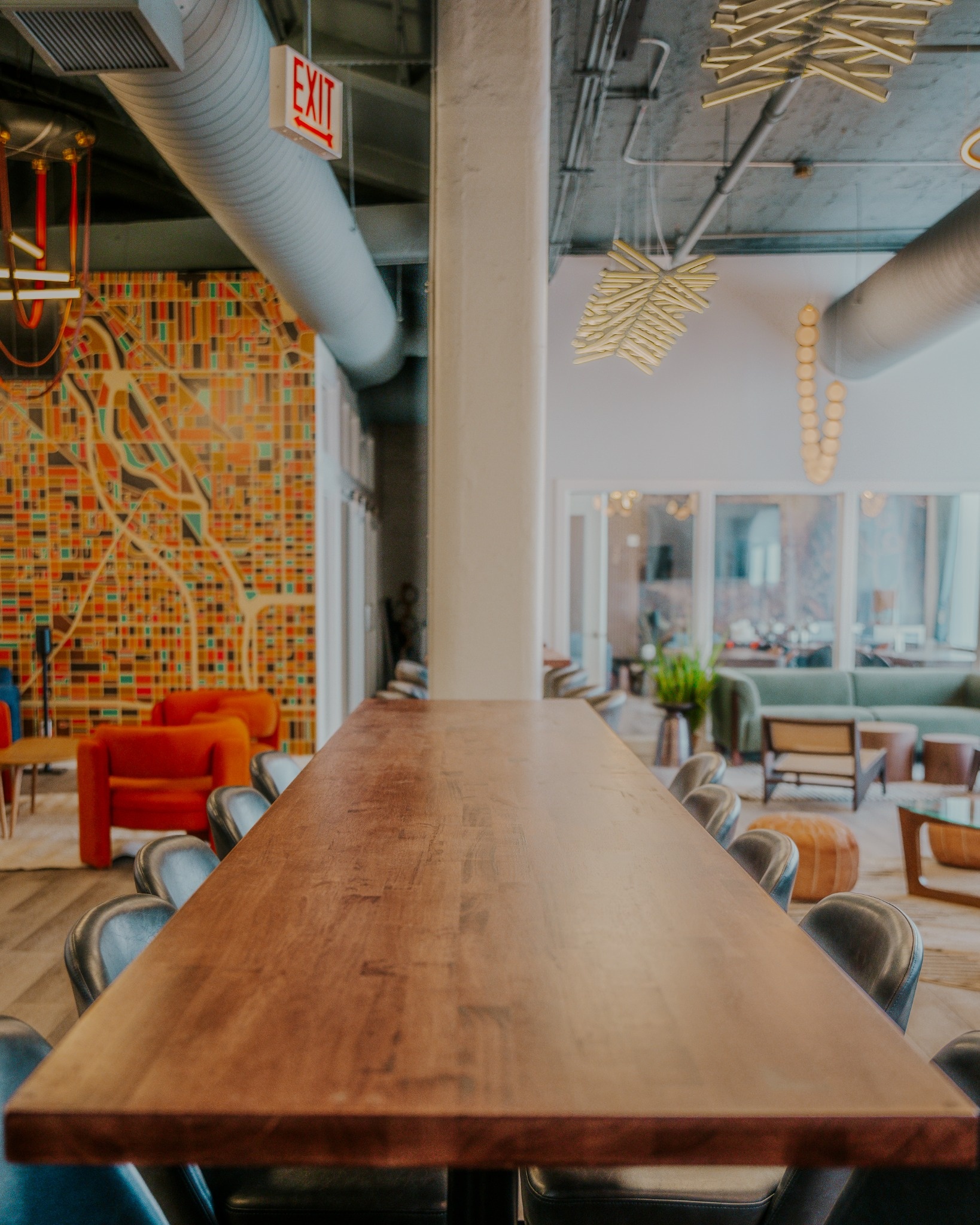 The long bar table and Chicago map mural at the River North clubhouse