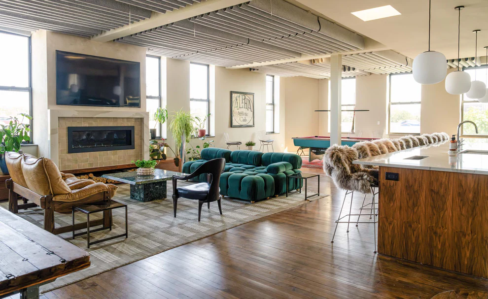 The Firehouse Lounge main room with fireplace, lounge seating, and pool table